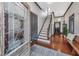 Inviting foyer with hardwood floors, decorative glass front door and staircase at 207 S Gum St, Summerville, SC 29483