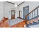 Foyer featuring hardwood floors, staircase, decorative glass front door and wooden bench at 207 S Gum St, Summerville, SC 29483