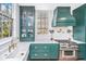 The kitchen features custom green cabinets, stainless steel appliances, and Carrara marble countertops at 207 S Gum St, Summerville, SC 29483