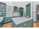 Gourmet kitchen featuring an island, marble countertops, stainless appliances, and custom green cabinets at 207 S Gum St, Summerville, SC 29483