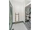 Laundry room with stackable washer and dryer, ladder, and patterned tile flooring at 207 S Gum St, Summerville, SC 29483