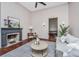Cozy living room featuring hardwood floors, fireplace and gray sofa at 207 S Gum St, Summerville, SC 29483