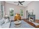 Bright living room with a fireplace, hardwood floors and ample natural light at 207 S Gum St, Summerville, SC 29483