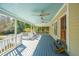 Inviting covered porch with painted blue ceiling, ceiling fans, and comfortable seating area at 207 S Gum St, Summerville, SC 29483