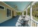 Inviting covered porch with painted blue ceiling, ceiling fans, and comfortable seating area at 207 S Gum St, Summerville, SC 29483