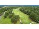 Aerial view of a lush green golf course surrounded by mature trees at 2124 Tall Grass Cir, Mount Pleasant, SC 29466