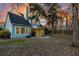 Backyard view of a charming two-story home with a screened porch and partially wooded lot at 2124 Tall Grass Cir, Mount Pleasant, SC 29466