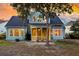 Backyard view of a charming two-story home with a screened porch and partially wooded lot at 2124 Tall Grass Cir, Mount Pleasant, SC 29466