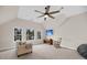 Bright bonus room with large windows, neutral carpet, ceiling fan, and a comfortable seating area at 2124 Tall Grass Cir, Mount Pleasant, SC 29466