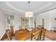 Elegant dining room with hardwood floors, tray ceiling, and seating for six at 2124 Tall Grass Cir, Mount Pleasant, SC 29466