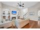 Open living room with fireplace, built-in shelving, hardwood floors, and a ceiling fan at 2124 Tall Grass Cir, Mount Pleasant, SC 29466