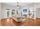 Bright living room featuring hardwood floors, fireplace, built-in shelves, and large windows at 2124 Tall Grass Cir, Mount Pleasant, SC 29466