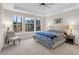 Bright main bedroom features a tray ceiling, large windows, and a chair, creating a cozy retreat at 2124 Tall Grass Cir, Mount Pleasant, SC 29466