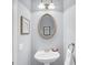 Powder room with pedestal sink, oval mirror, and modern lighting at 2124 Tall Grass Cir, Mount Pleasant, SC 29466