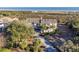 Expansive beach home featuring a long driveway, mature palms, and scenic views of the beach and the ocean at 2238 Catesbys Blf, Seabrook Island, SC 29455
