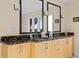 Bathroom with double sink vanity, black granite countertops, and stylish fixtures at 2238 Catesbys Blf, Seabrook Island, SC 29455