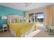 Cozy bedroom with a bright yellow comforter, a unique headboard, and access to a private balcony at 2238 Catesbys Blf, Seabrook Island, SC 29455