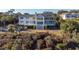 Stately two-story home featuring a large deck, ample windows and an elegant staircase leading to the yard at 2238 Catesbys Blf, Seabrook Island, SC 29455