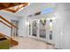 Bright foyer with tiled flooring, a staircase, and glass doors leading to the exterior, creating a welcoming entrance at 2238 Catesbys Blf, Seabrook Island, SC 29455
