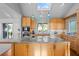 Kitchen island with granite countertops, wood cabinets, and a skylight at 2238 Catesbys Blf, Seabrook Island, SC 29455