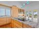 Granite kitchen island with wood cabinets, bar seating, and stainless appliances at 2238 Catesbys Blf, Seabrook Island, SC 29455