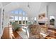 Bright living room boasts high ceilings, large windows with scenic views, comfortable seating, and hardwood floors at 2238 Catesbys Blf, Seabrook Island, SC 29455