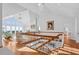 Living room with high vaulted ceilings, hardwood floors, a chandelier, and expansive windows offering panoramic views at 2238 Catesbys Blf, Seabrook Island, SC 29455