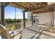 Relaxing covered porch with a wooden swing and seating, perfect for enjoying the outdoors at 2238 Catesbys Blf, Seabrook Island, SC 29455