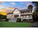 Expansive two-story home featuring multiple balconies and a well-manicured lawn at 2238 Catesbys Blf, Seabrook Island, SC 29455