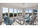 Inviting sunroom featuring large windows, a ceiling fan, and a cozy seating area to enjoy the scenery at 2238 Catesbys Blf, Seabrook Island, SC 29455