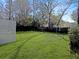 Lush backyard with a spacious lawn, offering a serene outdoor space and partial fence at 2320 Chadbury Ln, Mount Pleasant, SC 29466