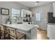 Open kitchen with a breakfast bar, white cabinets, modern backsplash and stainless steel appliances at 2320 Chadbury Ln, Mount Pleasant, SC 29466