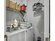 Efficient laundry room with washer, dryer, shelving, and practical storage solutions at 2320 Chadbury Ln, Mount Pleasant, SC 29466