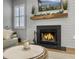 Cozy living room features a stone fireplace, a mantel with plants, and a wall-mounted television at 2320 Chadbury Ln, Mount Pleasant, SC 29466