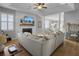 Inviting living room with fireplace, seamlessly connected to the bright dining area and modern kitchen at 2320 Chadbury Ln, Mount Pleasant, SC 29466