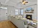 Stylish living room with a fireplace, hardwood floors, and ample natural light creating a warm atmosphere at 2320 Chadbury Ln, Mount Pleasant, SC 29466