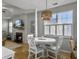 Open-concept living space with dining area, fireplace, and views of a backyard at 2320 Chadbury Ln, Mount Pleasant, SC 29466