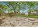 A backyard with a concrete area featuring some tables, chairs, and a privacy fence at 2420 Cherokee Hall Ln, Charleston, SC 29414
