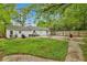 Spacious backyard featuring a concrete patio, wooden fence, and lush green lawn, perfect for outdoor entertaining at 2420 Cherokee Hall Ln, Charleston, SC 29414