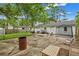 A backyard with a concrete area featuring some tables, chairs, and a privacy fence at 2420 Cherokee Hall Ln, Charleston, SC 29414