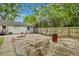 A backyard with a concrete area featuring some tables, chairs, and a privacy fence at 2420 Cherokee Hall Ln, Charleston, SC 29414