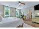 Bright bedroom features two windows, a ceiling fan, and accent furniture at 2420 Cherokee Hall Ln, Charleston, SC 29414