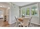 Bright dining area with wood floors, decorative lights, and large windows overlooking the front yard at 2420 Cherokee Hall Ln, Charleston, SC 29414