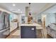 Open kitchen with a central island and bar stools at 2420 Cherokee Hall Ln, Charleston, SC 29414
