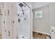 Modern shower with black shower head, storage, and glass door at 2420 Cherokee Hall Ln, Charleston, SC 29414