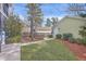 Manicured backyard with lush green lawn and walkway to garage at 2615 Rutherford Way, Charleston, SC 29414
