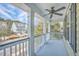 Open-air balcony with white columns and black railings provides scenic views of the neighborhood and trees at 2615 Rutherford Way, Charleston, SC 29414