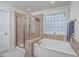 Well-appointed bathroom with a glass-enclosed shower, soaking tub, and stylish tile work at 2615 Rutherford Way, Charleston, SC 29414