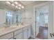 Bright bathroom with double vanity, granite countertops, framed mirrors, and stylish lighting fixtures at 2615 Rutherford Way, Charleston, SC 29414