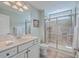 Bright bathroom with a granite countertop vanity and a glass shower with ceramic tile surround at 2615 Rutherford Way, Charleston, SC 29414